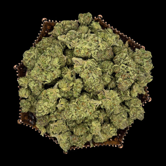 Greenhouse THCA flower buds arranged in a hexagonal copper tray, photographed on black