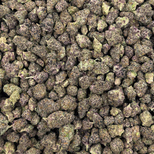 Close-up of THCA small buds filling the frame, purple and green, photographed from above
